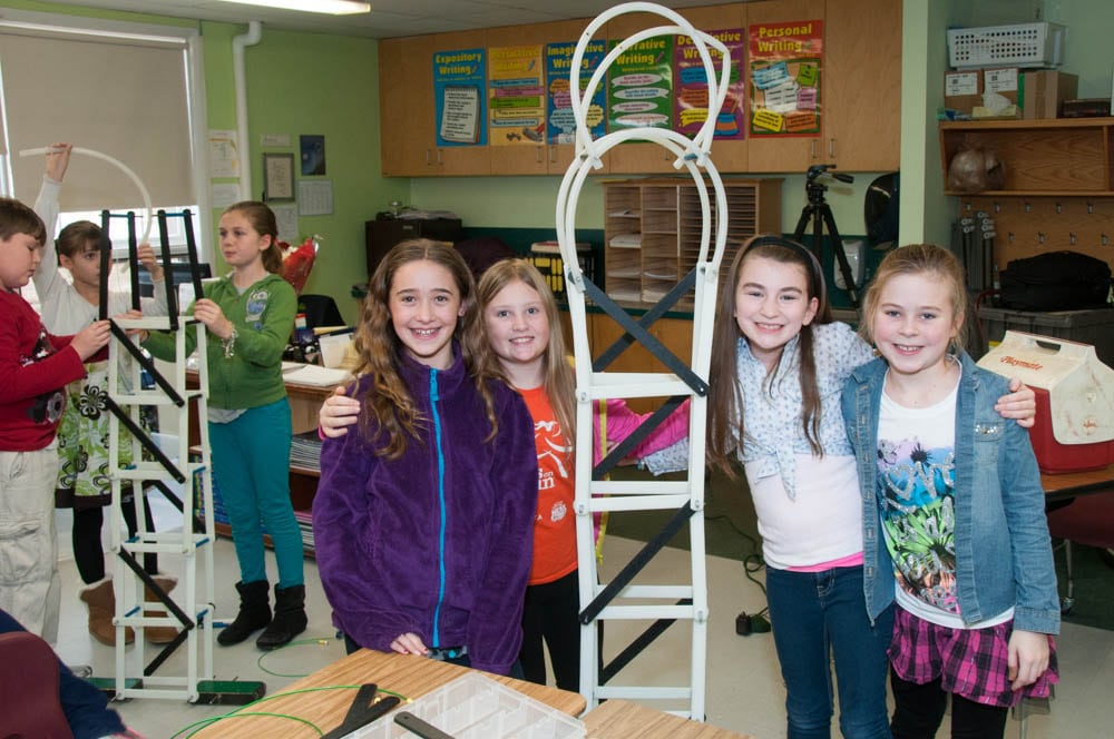 students standing next to tower