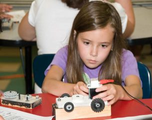 kid working on car